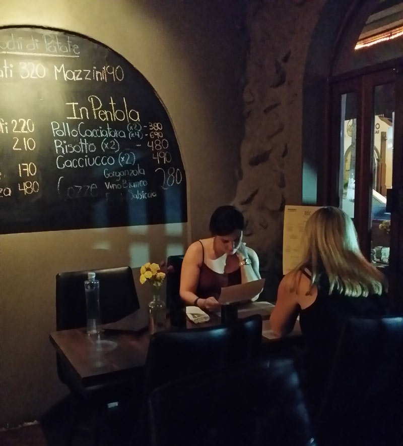 Two women diners inside at Doc Wine Bar, Cabo San Lucas