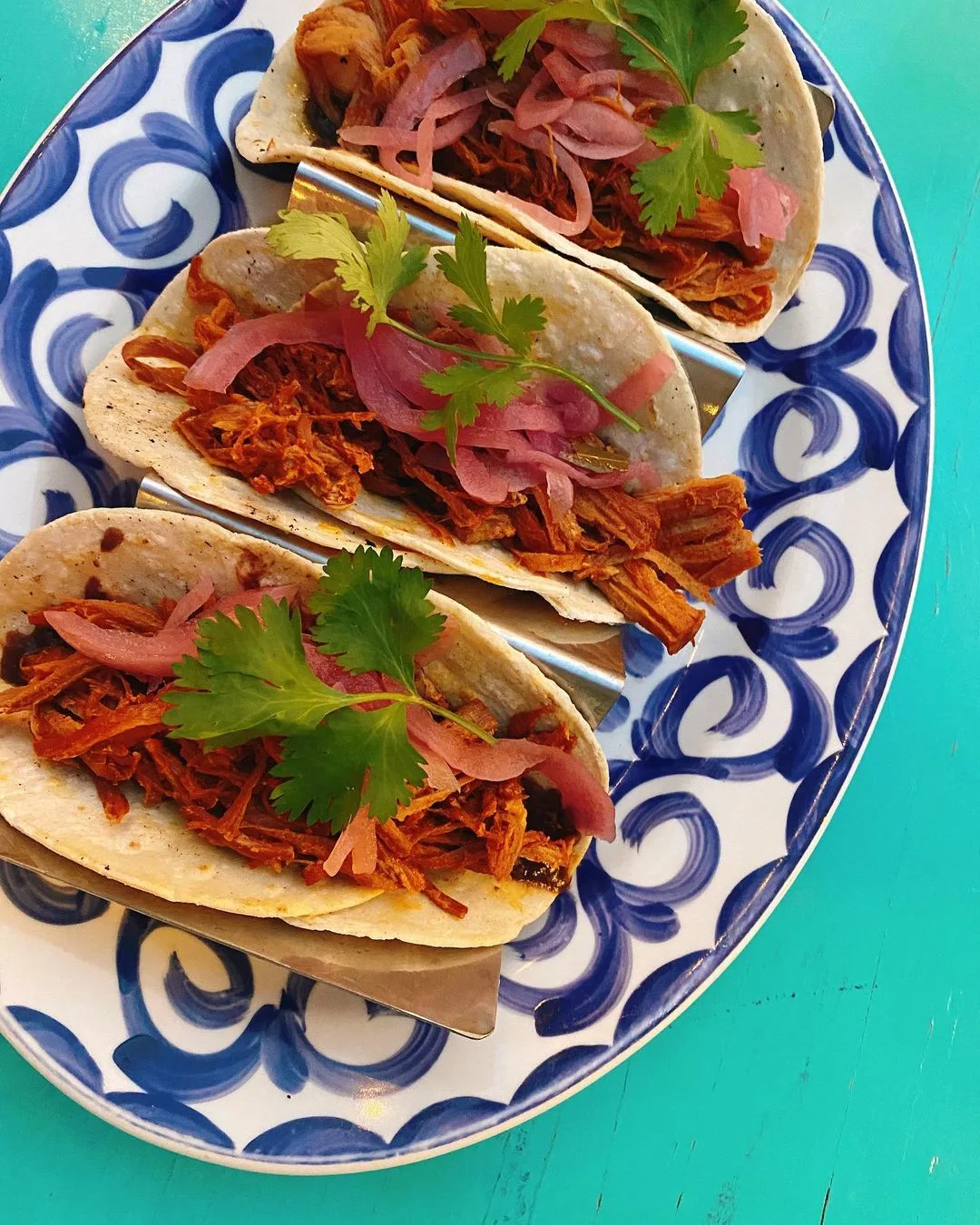 Cochinita pibil tacos on a blue-and-white plate at Mi Casa restaurant in Cabo San Lucas, Mexico