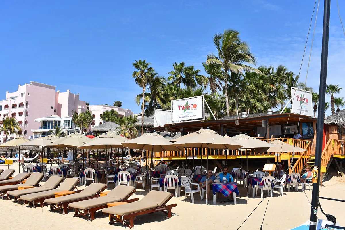 Beach chairs and tables in the sand at Tabasco Beach Restaurant and Bar in Cabo San Lucas