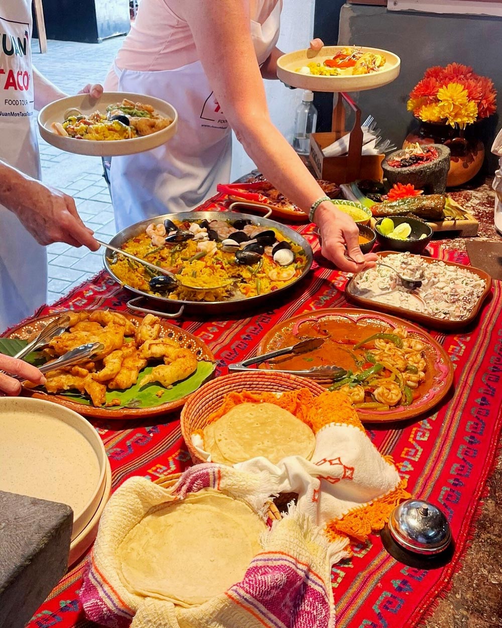 Plates of food on a red tablecloth at a Mexican cooking class in Cabo San Lucas