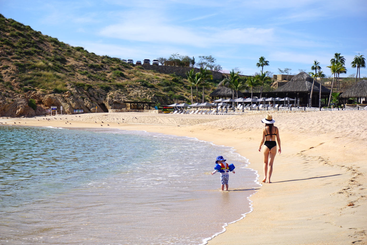 Mother and toddler walk along Santa Maria Beach, Cabo San Lucas