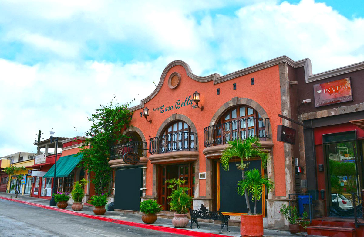 Red stone facade of Casa Bella hotel in Cabo San Lucas