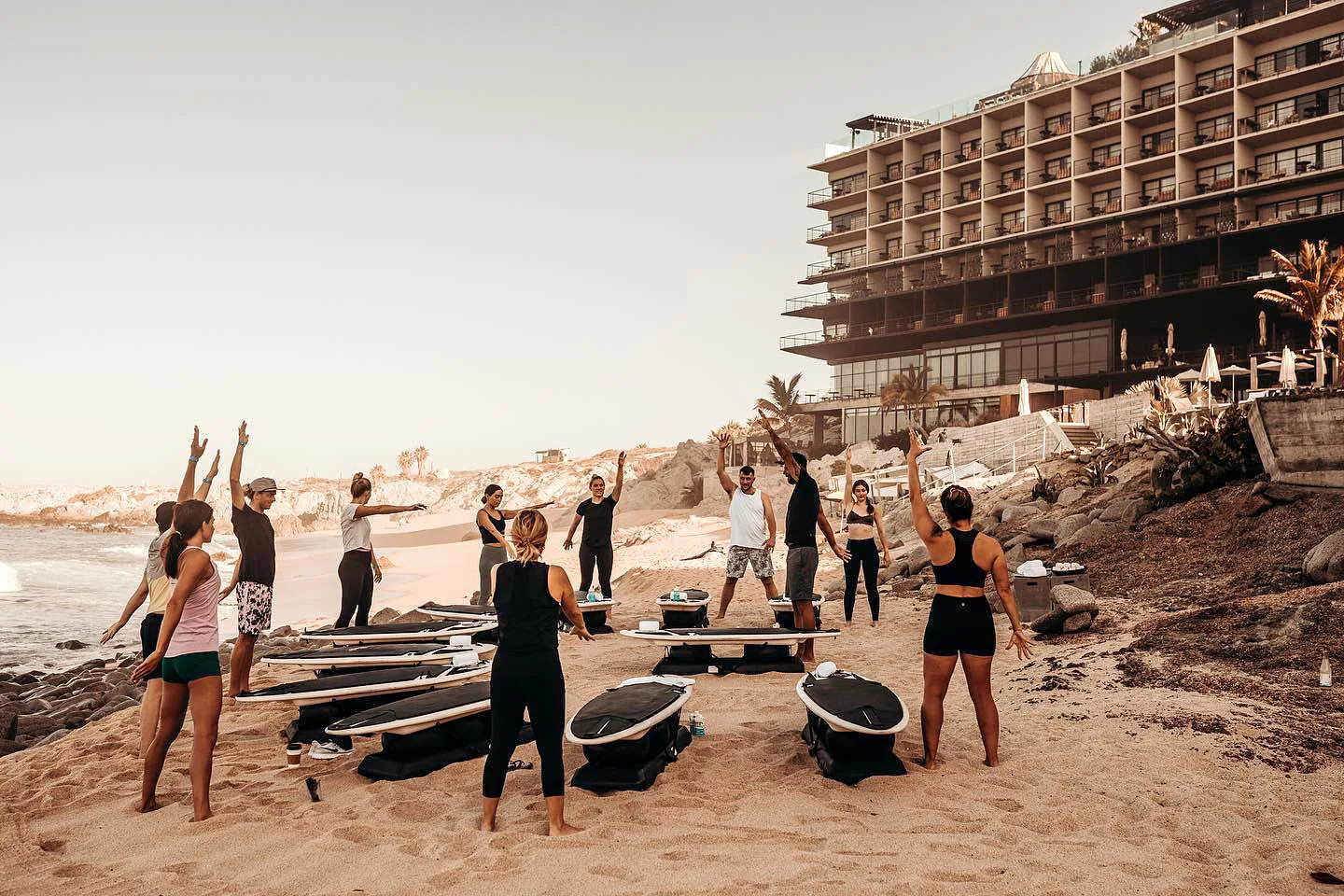 Surfing-style fitness class on the beach at The Cape, a Thompson Hotel