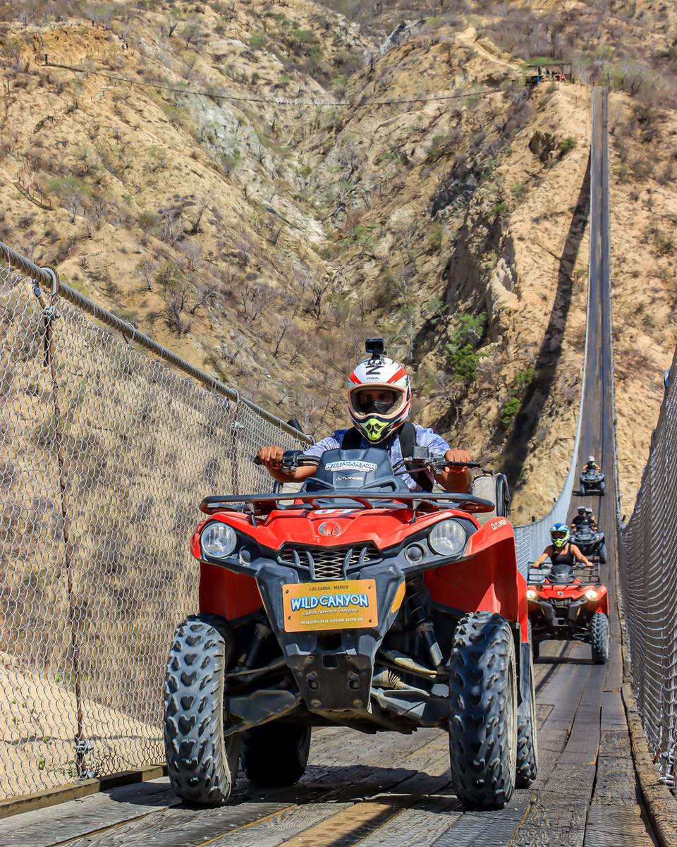 ATVs cross the Los Cabos Canyon Bridge