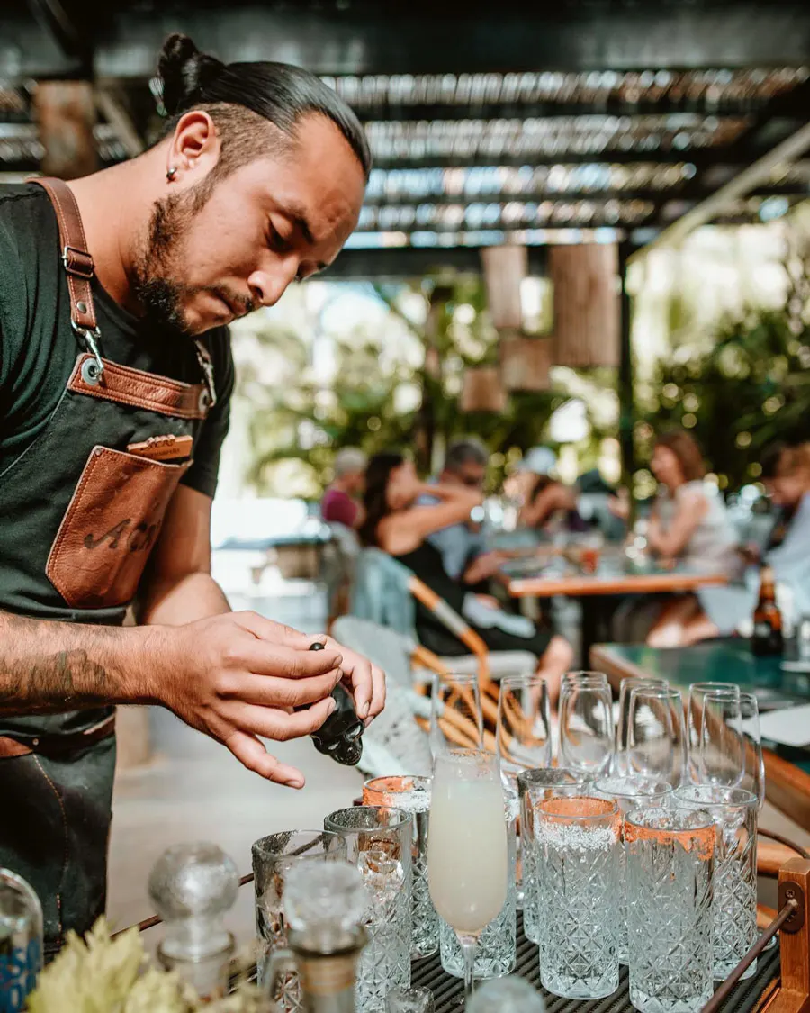Bartender making cocktails at Acre Restaurant, Cabo