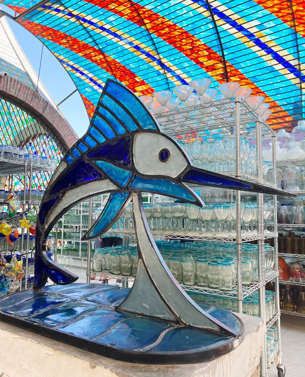 A huge blue glass Marlin sculpture at The Glass Factory