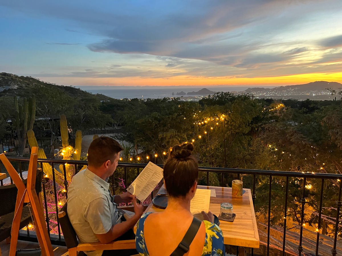 Couple enjoying the view of Cabo San Lucas' twinkling lights at Torote restaurant