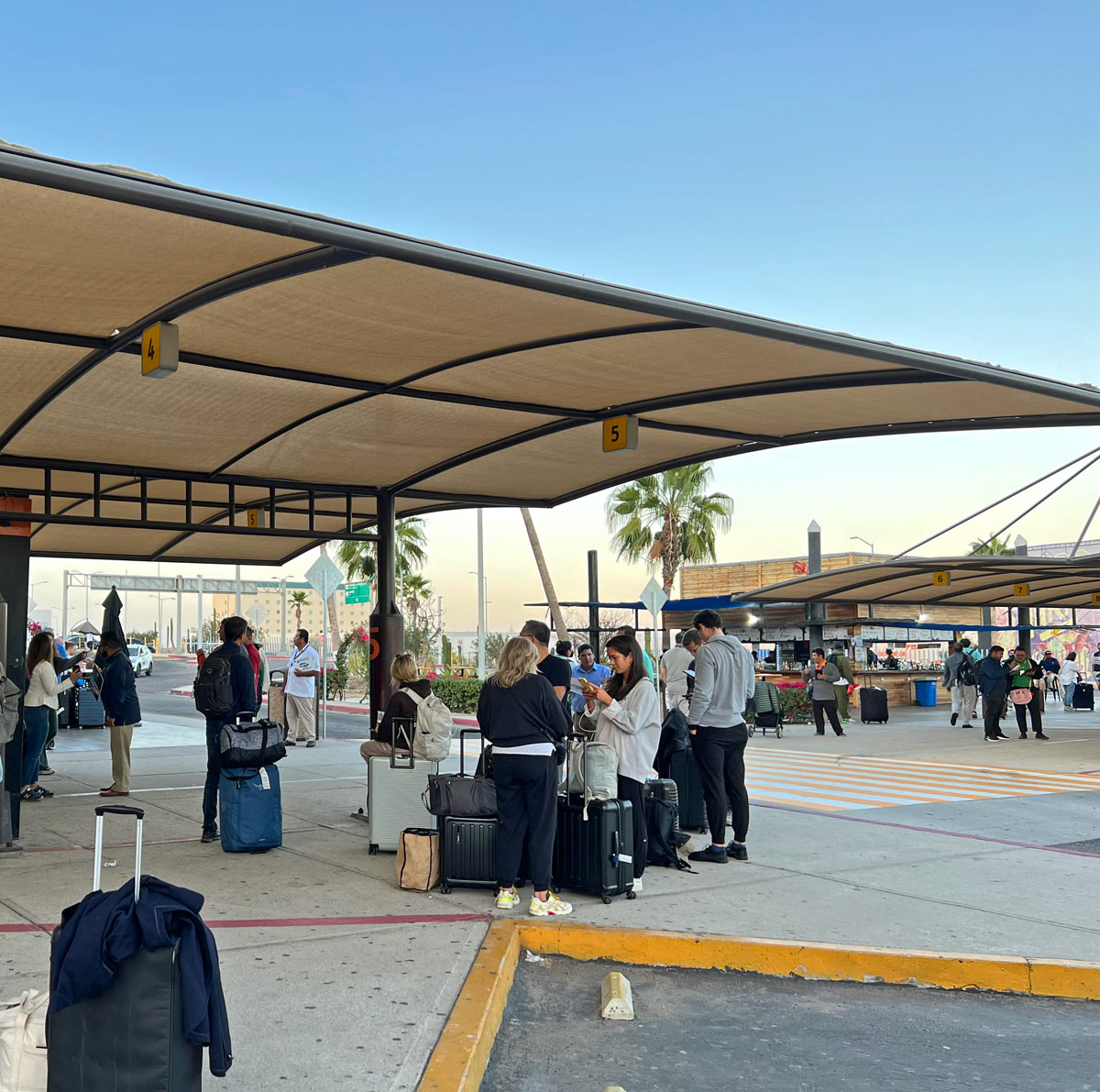 Visitors wait at the Cabo San Lucas airport for shuttles to their hotels