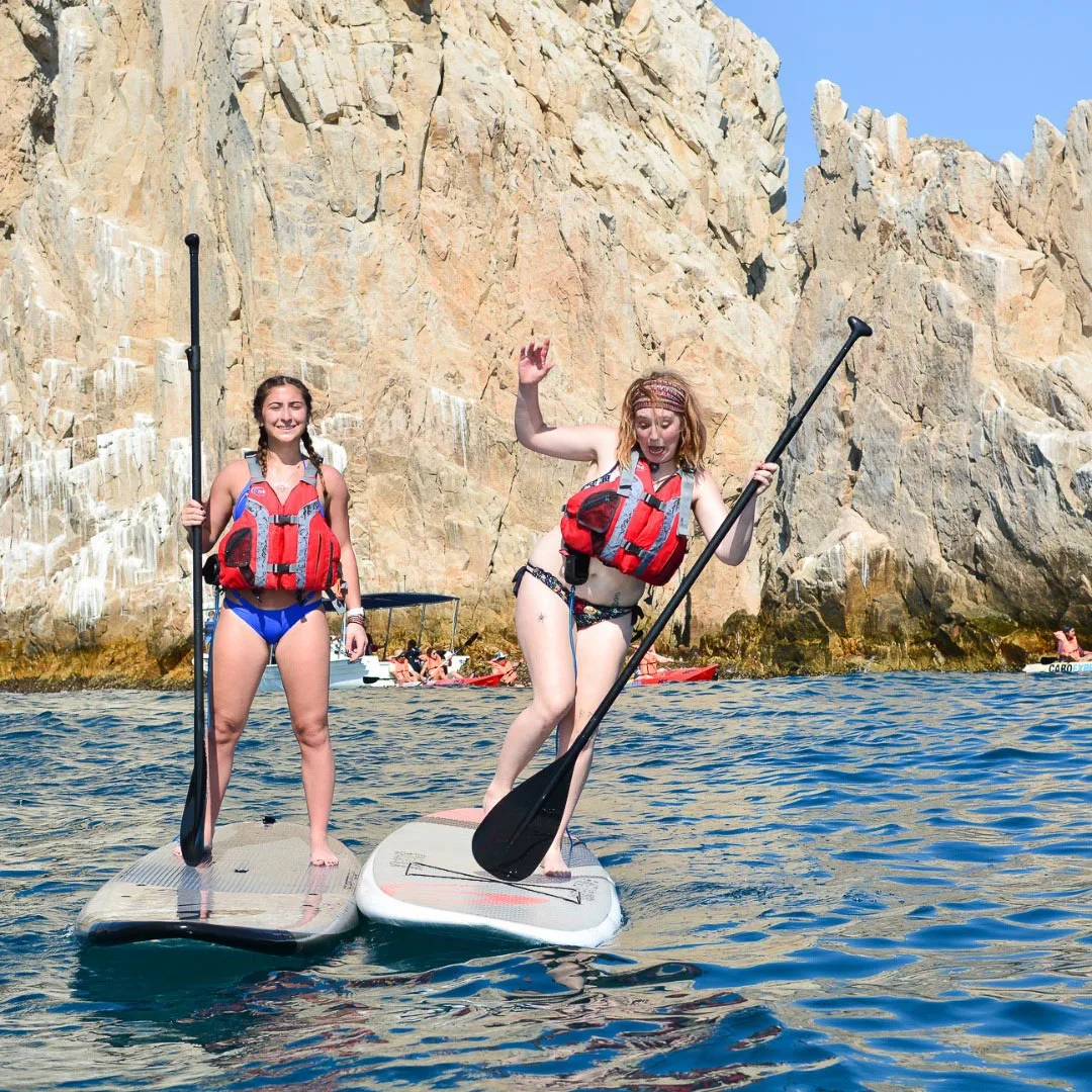 Two women on SUP boards at Land's End