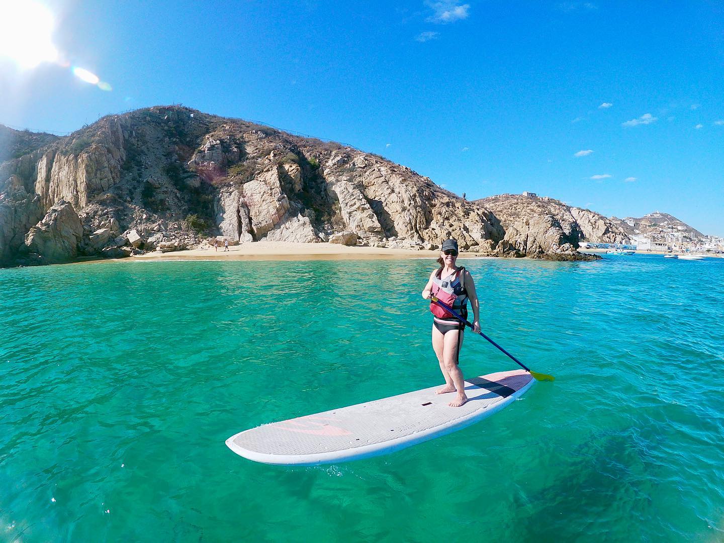 Woman on SUP board by Land's End