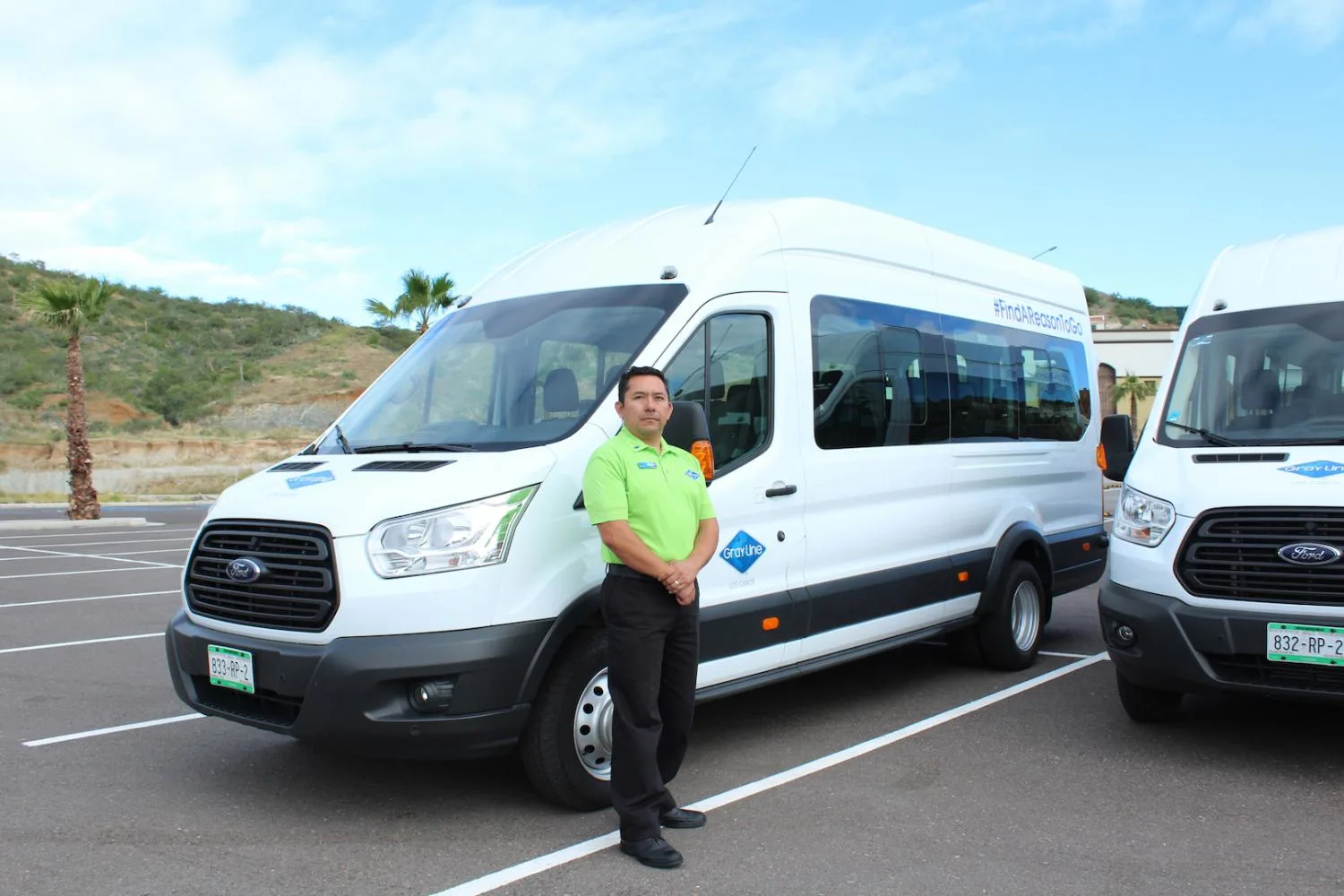 A white Gray Line van for airport transfers in Cabo