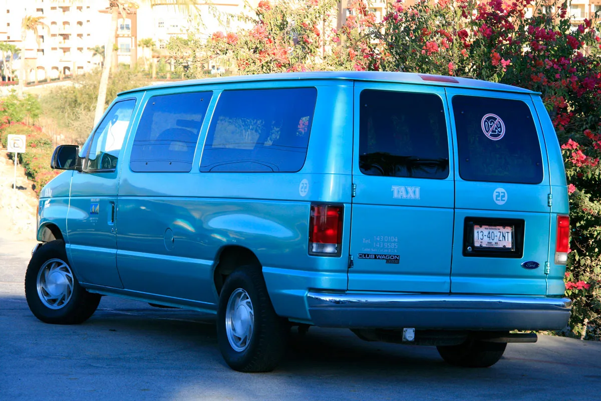 A blue taxi van in Cabo