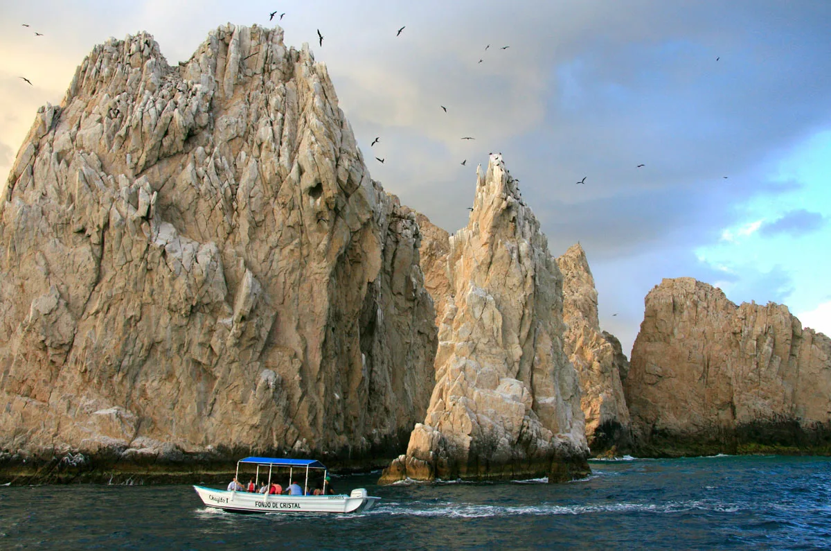 A water taxi cruises past Land's End, Cabo San Lucas