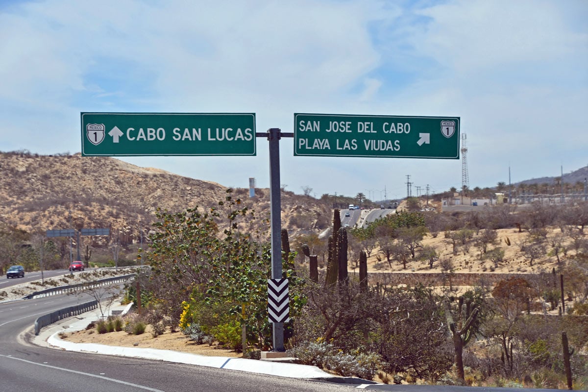 Highway 1 in the Los Cabos Tourist Corridor, with signs for Cabo San Lucas, San Jose del Cabo and Playa Las Viudas