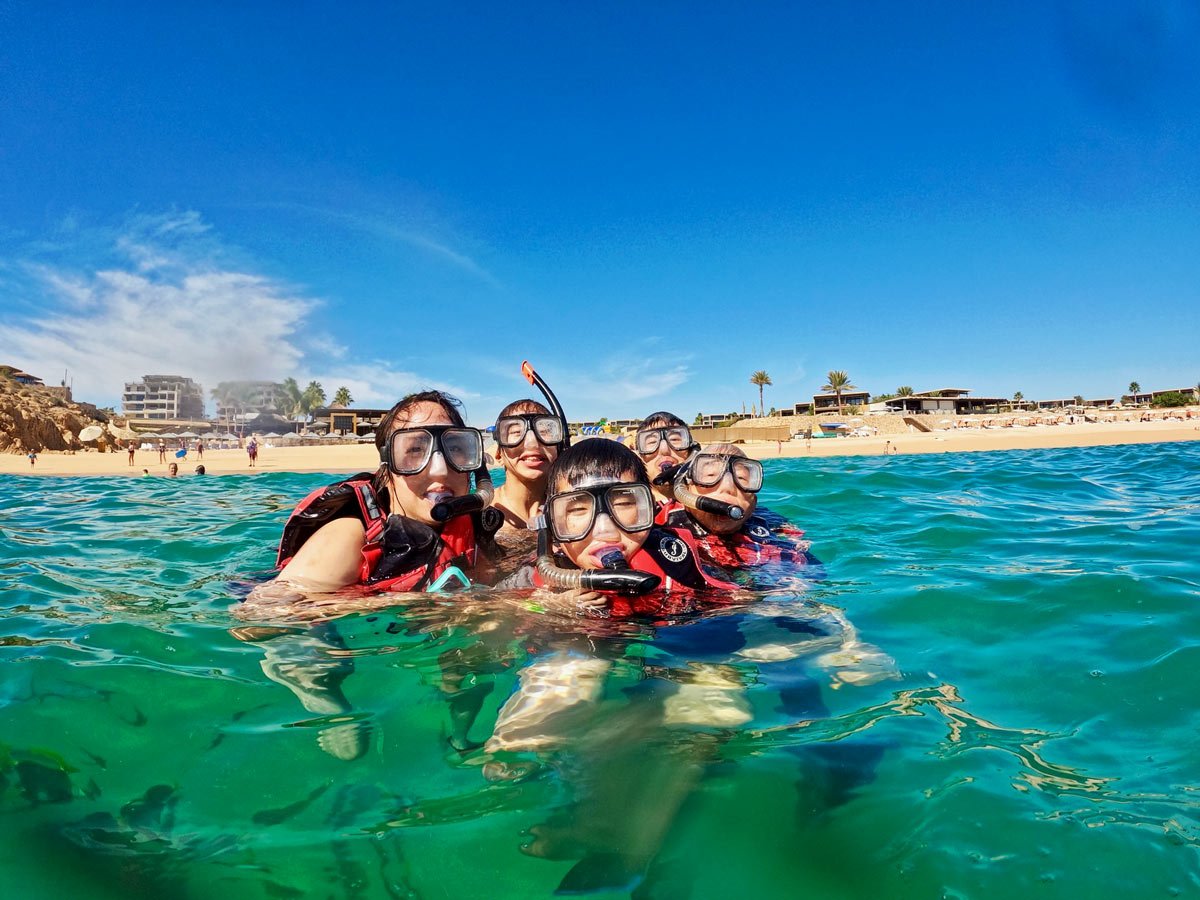 Family snorkeling at Santa Maria Bay, Los Cabos