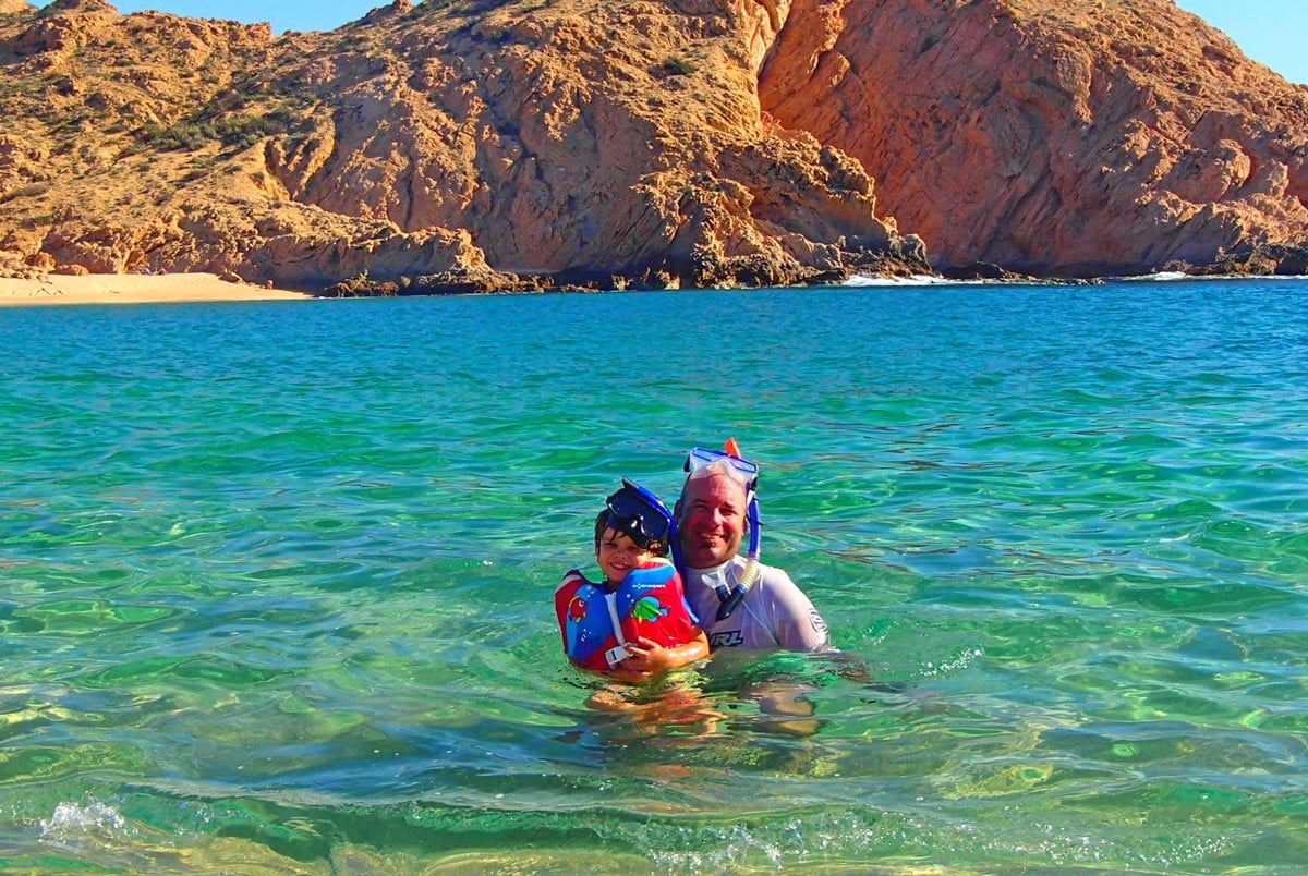 Father and son snorkeling at Santa Maria Bay