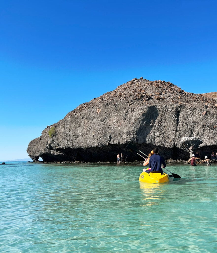 Couple in a yellow sea kayak at Mushroom Rock in Balandra Bay