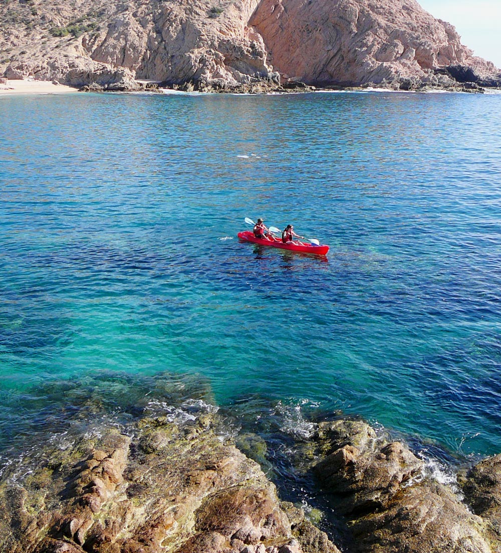 Couple paddle red kayak in Santa Maria Bay