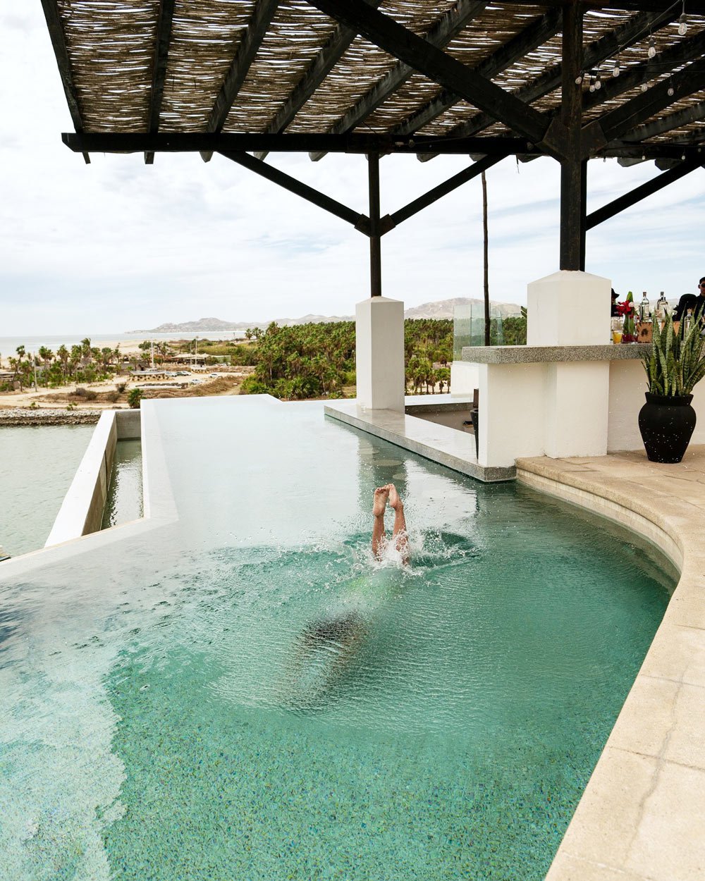 Woman swimming in Hotel El Ganzo's rooftop pool