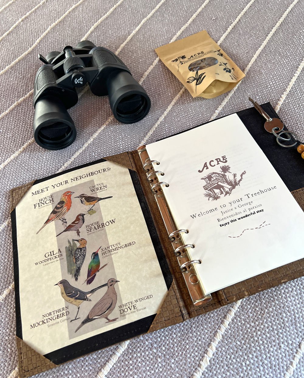 Binoculars and welcome guide for an Acre treehouse