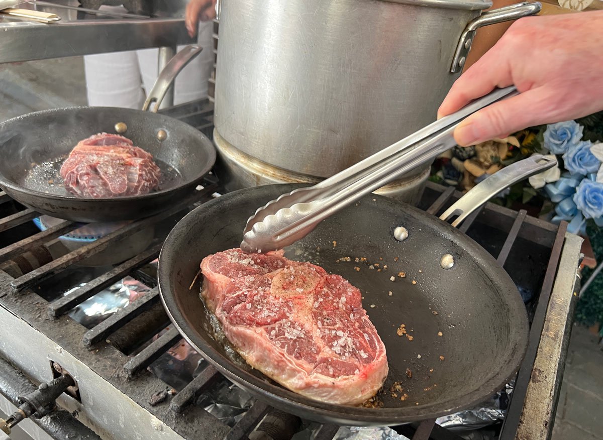 Frying beef during our Mexican cooking class in Cabo San Lucas