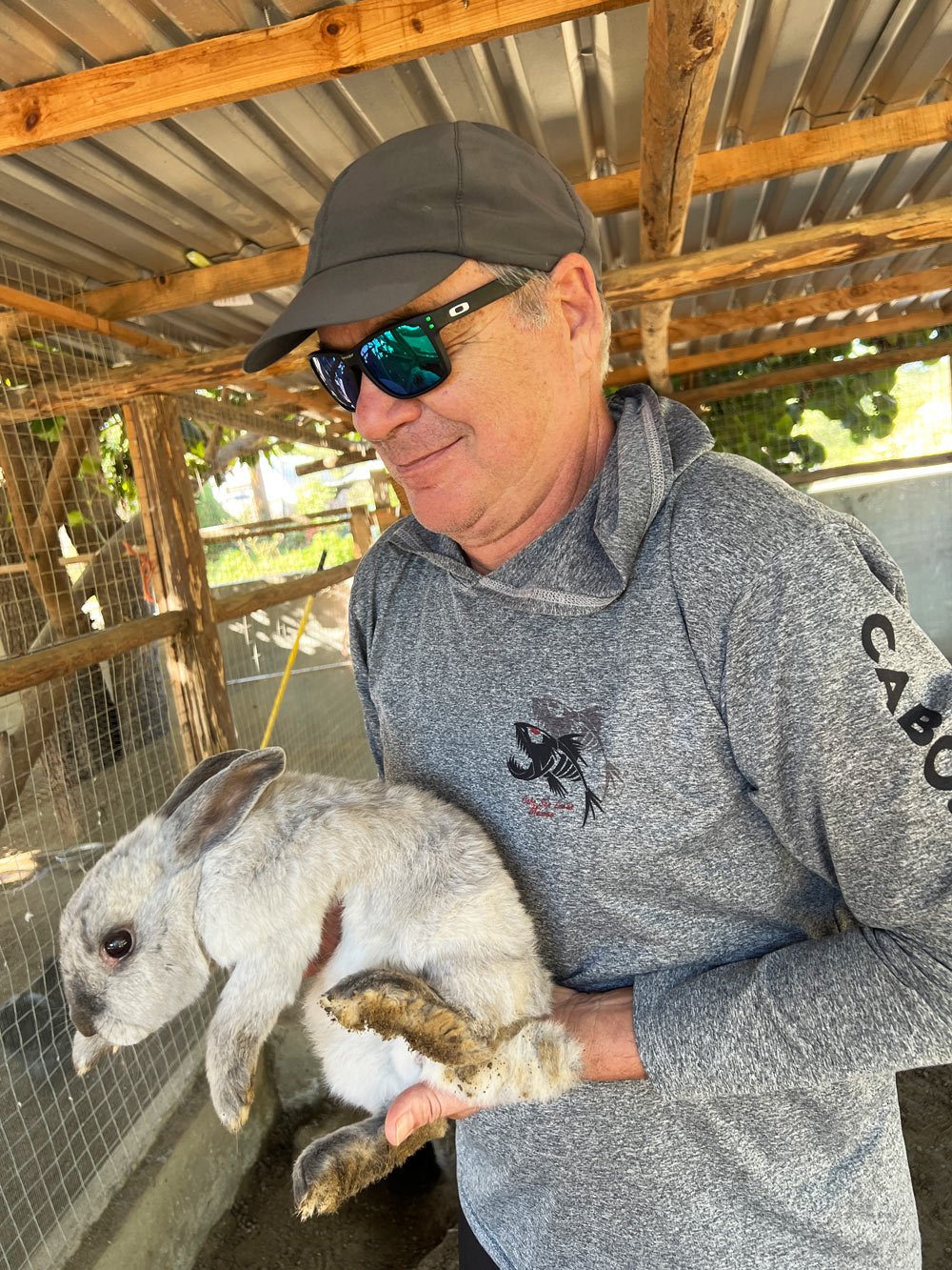 George petting a rabbit at Acre Resort's animal sanctuary