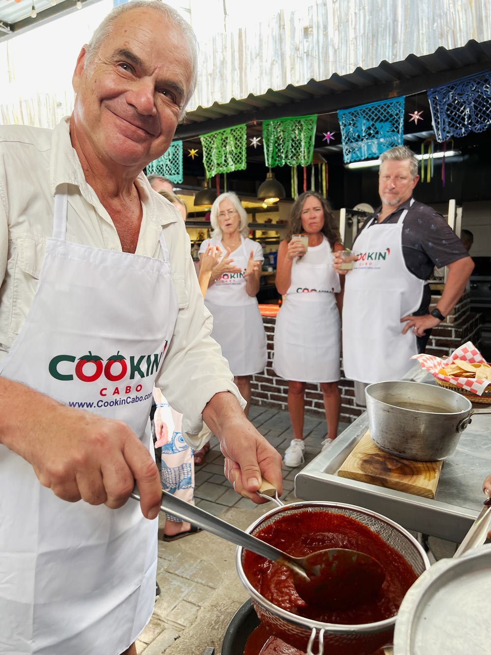 George making tomato sauce at a Mexican cooking class in Cabo San Lucas