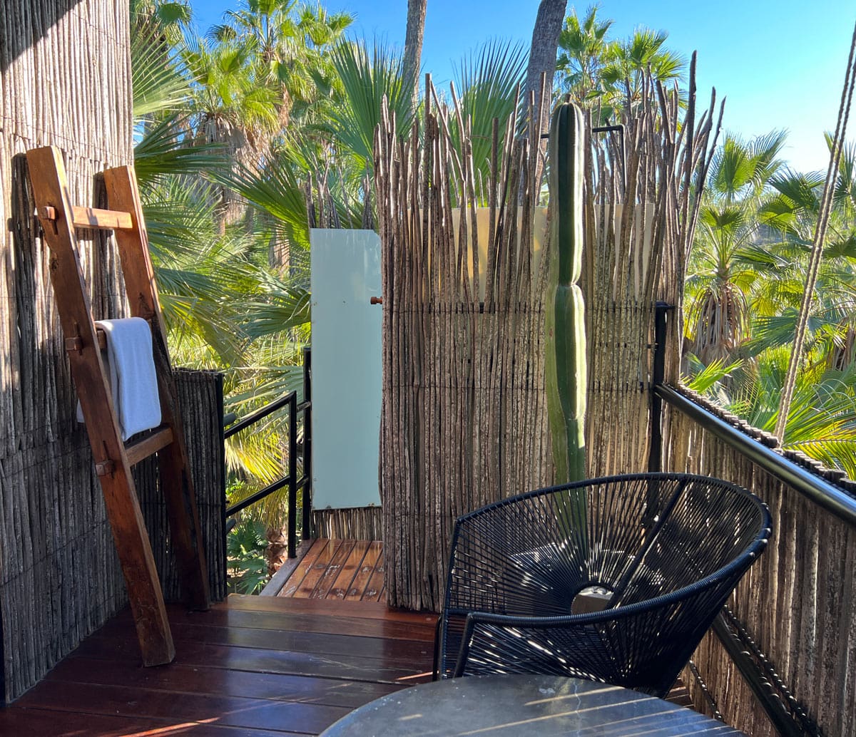Wooden treehouse porch with outdoor shower