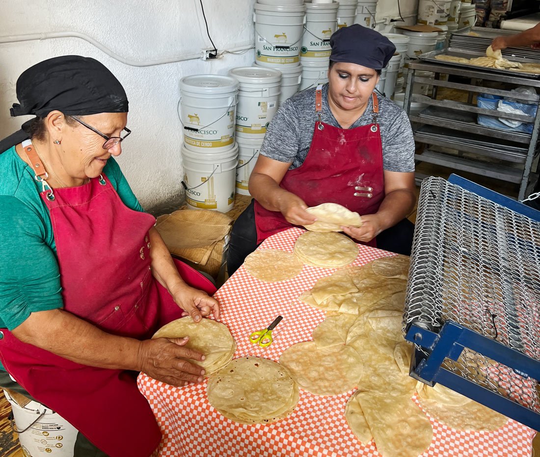 Two women make tortillas in Cabo San Lucas