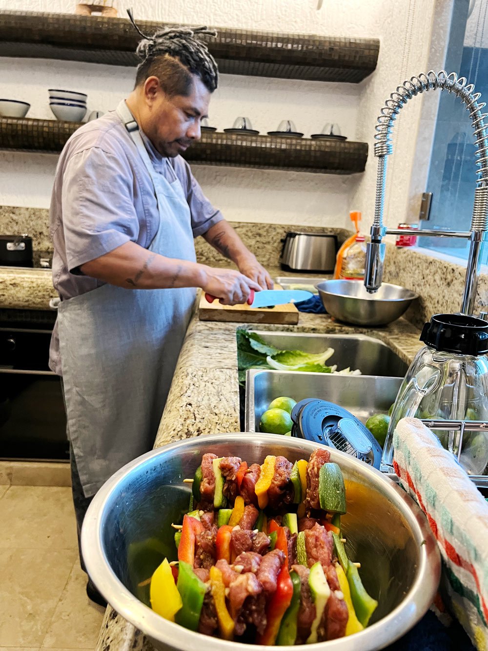 Chef Albert Martinez, a private chef in Cabo San Lucas, in the kitchen preparing our dinner