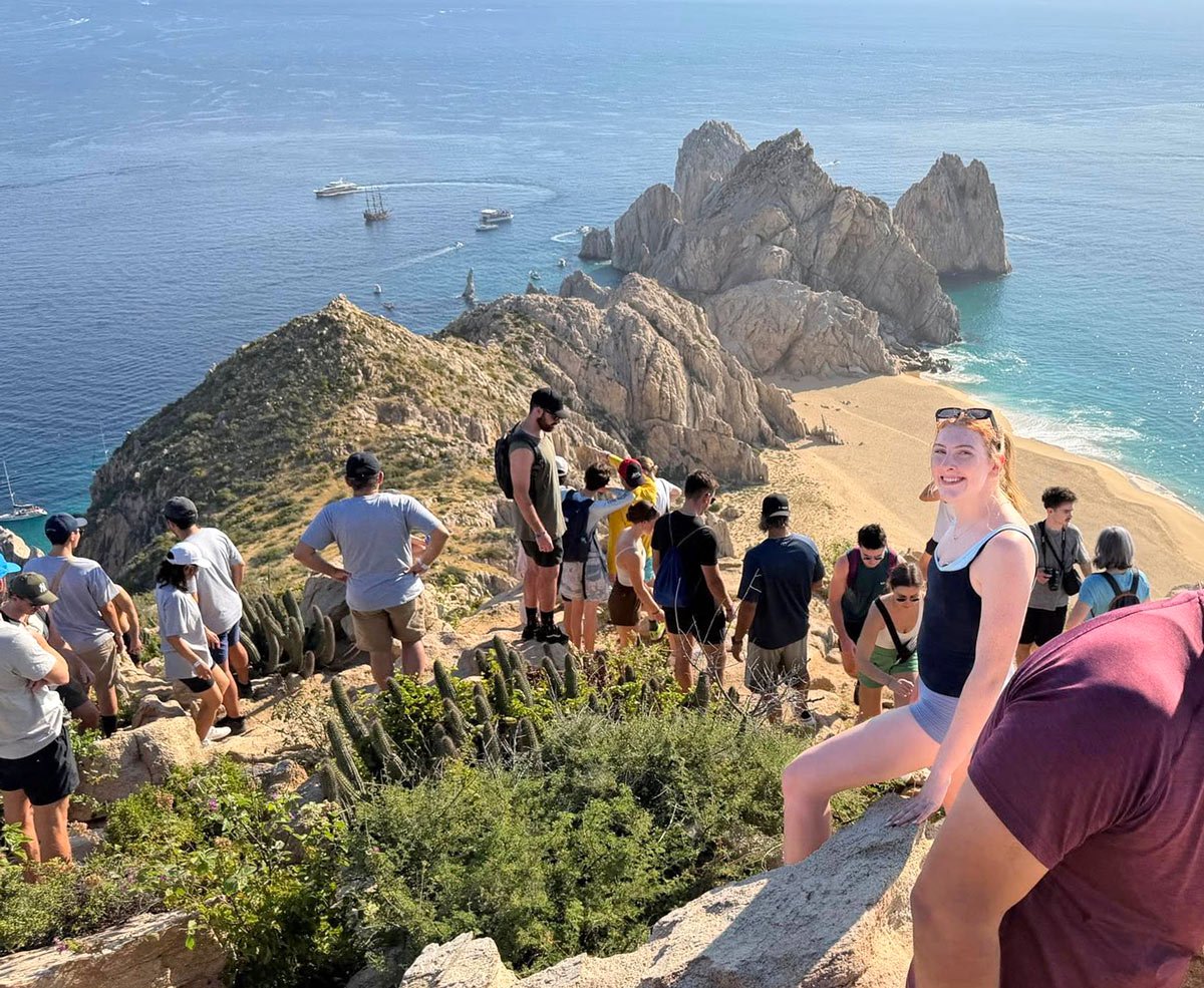 Hikers at top of Mt Solmar with the golden sands of Divorce Beach below