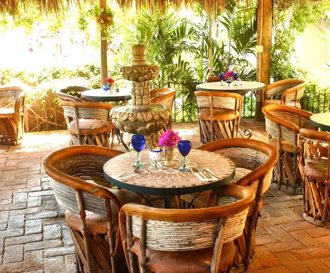 Mexican courtyard with leather bucket chairs and round tables